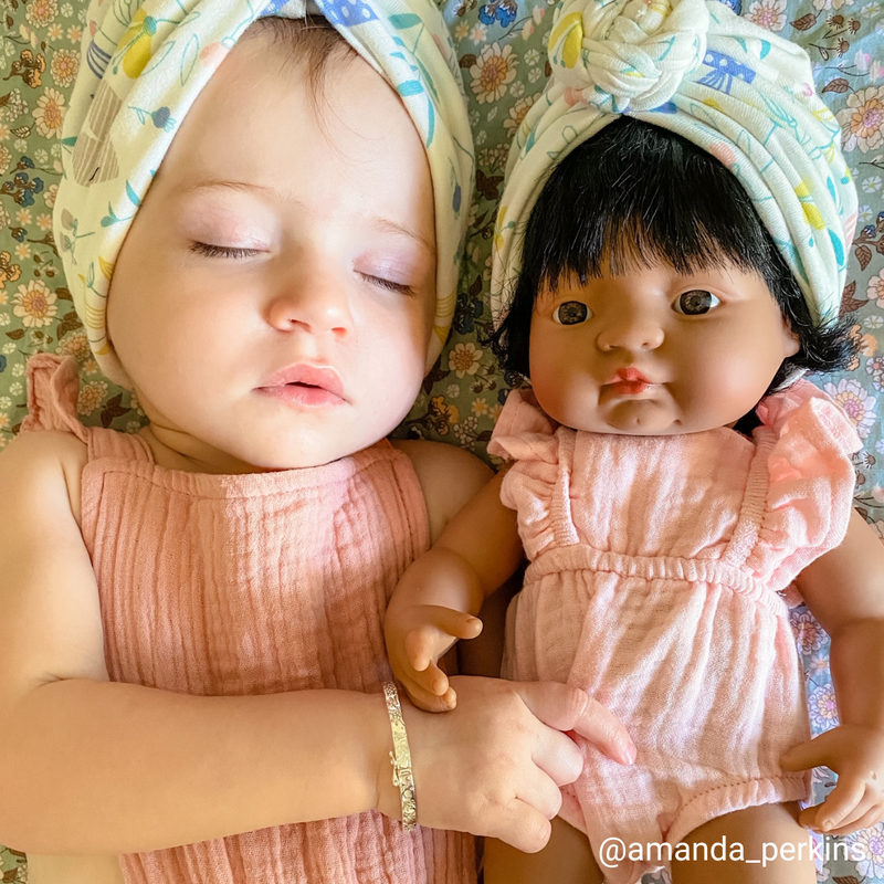 Sleeping baby with doll 